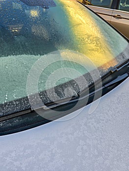 Frozen windscreen of a silver car in winter