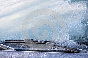 Frozen windscreen and windshield wipers totally covered with ice, caution, poor view causes dangerous driving im winter, traffic b