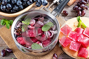 Frozen wine sauce in a stewpan on a wooden table