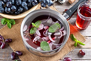 Frozen wine sauce in a stewpan on a wooden table