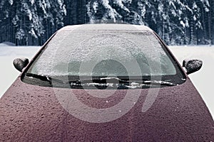 Frozen winter car covered snow, view front window windshield