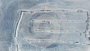 frozen in winter ice lake, docked in pier, aerial top down view