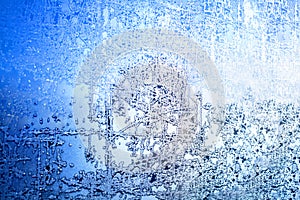 Frozen winter window, glass with frosty patterns, hoarfrost texture, snowflakes, New Year or Christmas ornament for banner