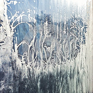 Frozen winter window with shiny ice frost pattern texture