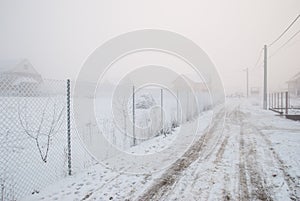 Frozen wire fence on a very cold and foggy winter day