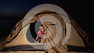 Frozen woman sitting in tent, bad accommodations in refugee camp, unhealthy