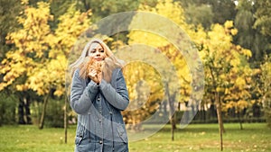 Frozen woman waiting for friend in autumn park, late for meeting, anticipation