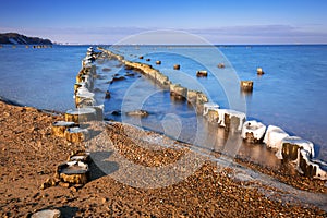 Frozen wooden breakwaters line