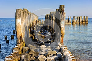 Frozen wooden breakwaters line at Baltic Sea