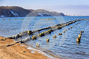 Frozen wooden breakwaters line at Baltic Sea