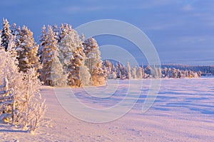 Frozen ÃâijÃÂ¤jÃÂ¤rvi lake in Finnish Lapland in winter at sunset photo