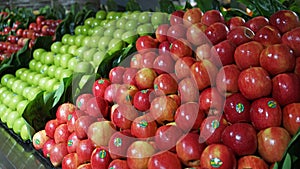 Fruit aisle with piles of red and green apples in Australian supermarket