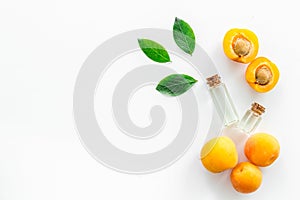 Fruit aroma oil. Apricot kernel oil on white background top view frame copy space