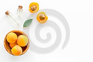 Fruit aroma oil. Apricot kernel oil on white background top view frame copy space