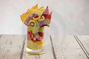 Fruit Avocado Cocktail cup on a wooden grungy table, Tropical fruits cocktail