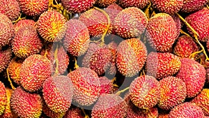 Fruit backdrop with bright red lychees clustered together