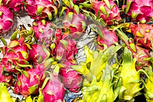 Fruit backdrop with vivid pink and yellow dragon fruit at a market