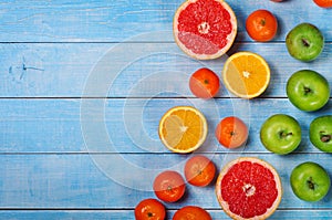 Fruit background - grapefruit, apples, oranges and tangerines