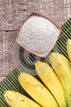 Fruit and banana powder on the wooden table Musa paradisiaca photo