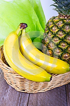 Fruit basket with bananas and ananas