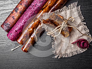 Fruit and berries pastille with linen thread on a wooden background close up