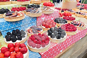 Fruit and berry tarts dessert tray assorted outdoors