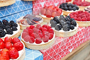 Fruit and berry tarts dessert tray assorted outdoors