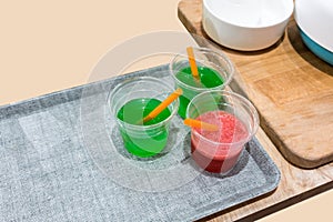 Fruit beverage samples with straws in small tasting cup