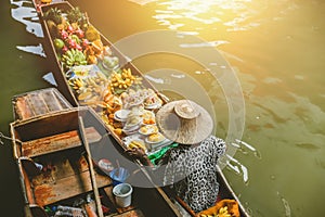 Fruit boat sale at Damnoen Saduak floating market. photo