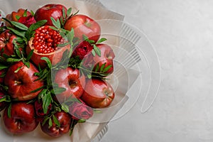 Fruit bouquet of apples, pomegranate and roses on a white background