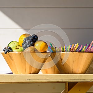 Fruit Bowl And Colorful Straws On Table