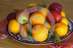 Fruit bowls filled with various types of fruit, tangerine mandarin oranges apples pears