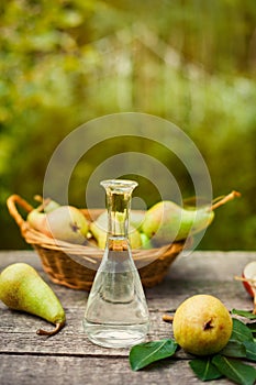 Fruit brandy in bottle and fresh pears