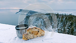 Fruit bread and tea with winter landscape background