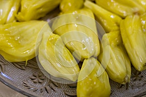 The Fruit Bulbs or Pods or edible pulps of jackfruit is placed in a plate. The scientific name of jackfruit is Artocarpus