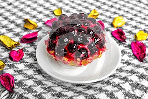 Fruit cake with currant covered with jelly on a saucer