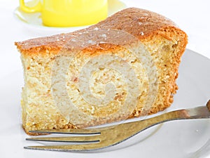 Fruit cake slice with fork.