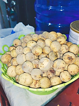 This fruit is called Duku.  it tastes sweet but sometimes a little sour.  This fruit comes from Indonesia. photo