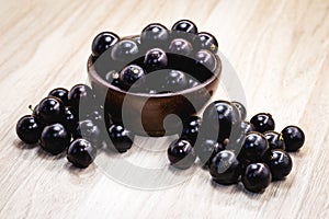 Fruit called Jaboticaba or jabuticaba in a basket on a white background, preserves organic and healthy fruits photo