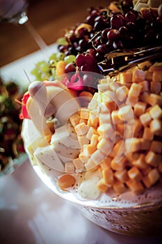 Fruit and cheese platter served on a table with natural light