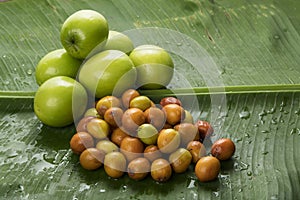 Fruit : Close up of Different Varieties of Indian Jujube Apple Isolated on Green Banana Leaf Background Shot in Studio