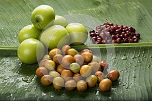 Fruit : Close up of Different Varieties of Indian Jujube Apple Isolated on Green Banana Leaf Background Shot in Studio