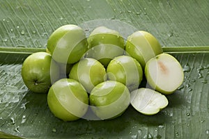Fruit : Close up of Indian Jujube Apple Isolated on Green Banana Leaf Background Shot in Studio