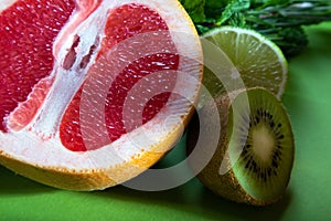 Fruit composition of cut red orange, lime, kiwi and verdure