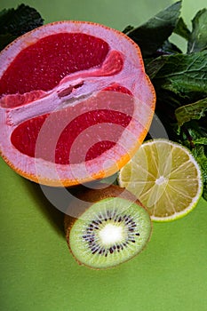 Fruit composition of cut red orange, lime, kiwi and verdure