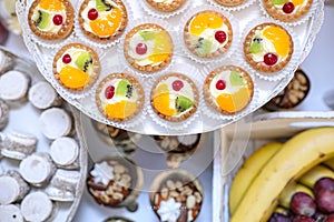 Fruit cupcakes decoration on a plate with cakes and fruits background