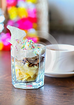 Fruit dessert with colorful sprinkles & cup of tea