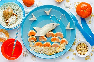 Fruit dolphin, summer season and sea vacation edible concept