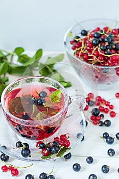 Fruit drink in transparent glass carafe and cup