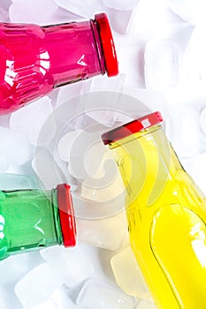 fruit drinks in colorful plastic bottles with ice top view mock-up